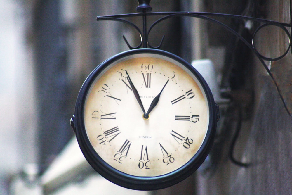 round black framed analog clock