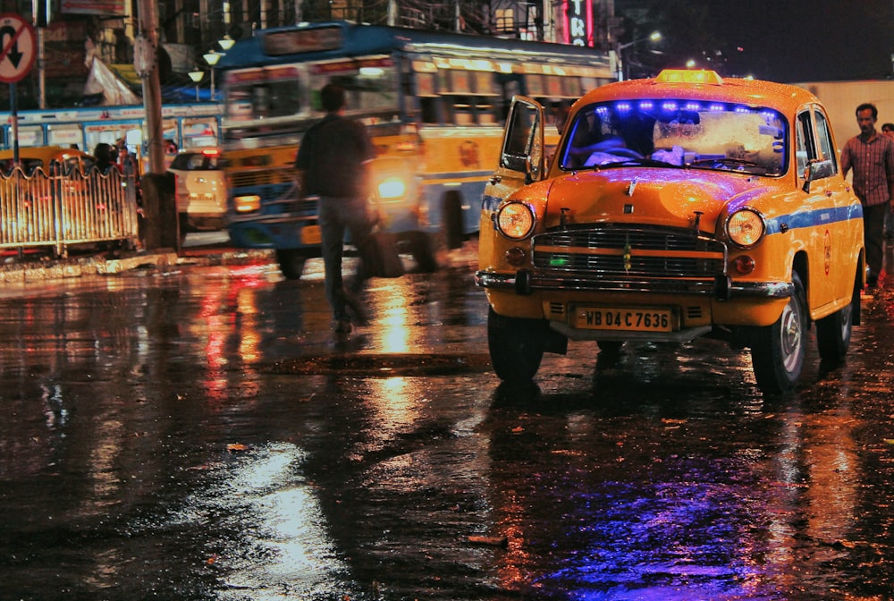 yellow vehicle traveling on road