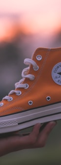 unpaired orange and white Converse All-Star high-top