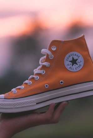 unpaired orange and white Converse All-Star high-top