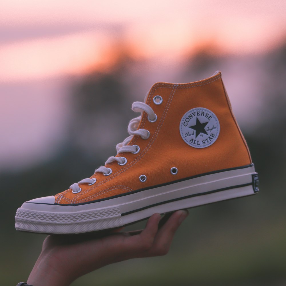 unpaired orange and white Converse All-Star high-top
