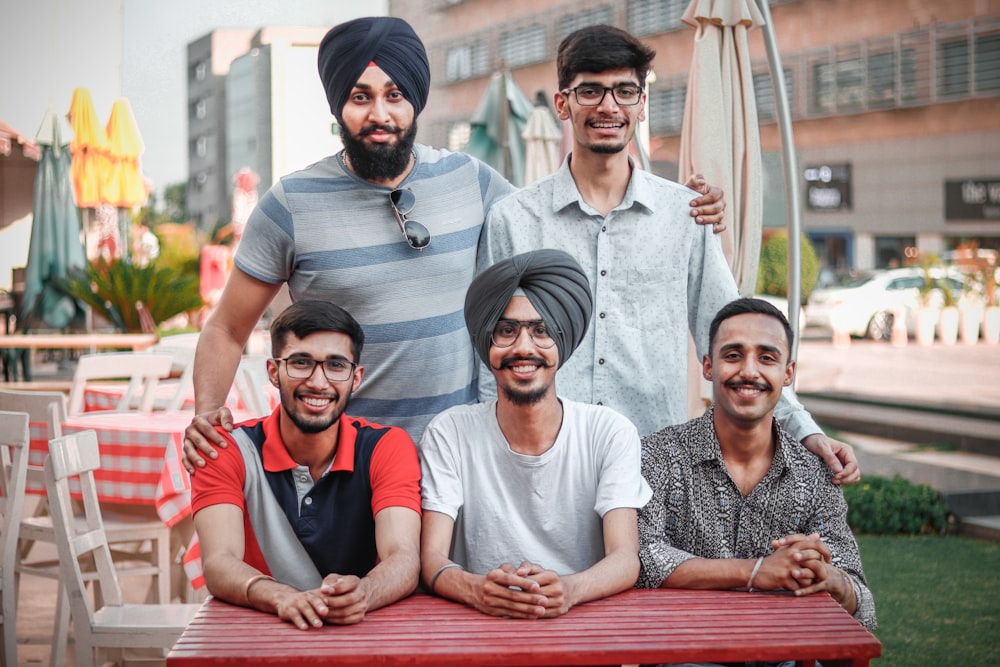 photography of five men near outdoor during daytime