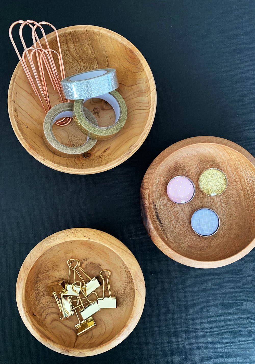 three round wooden bowls