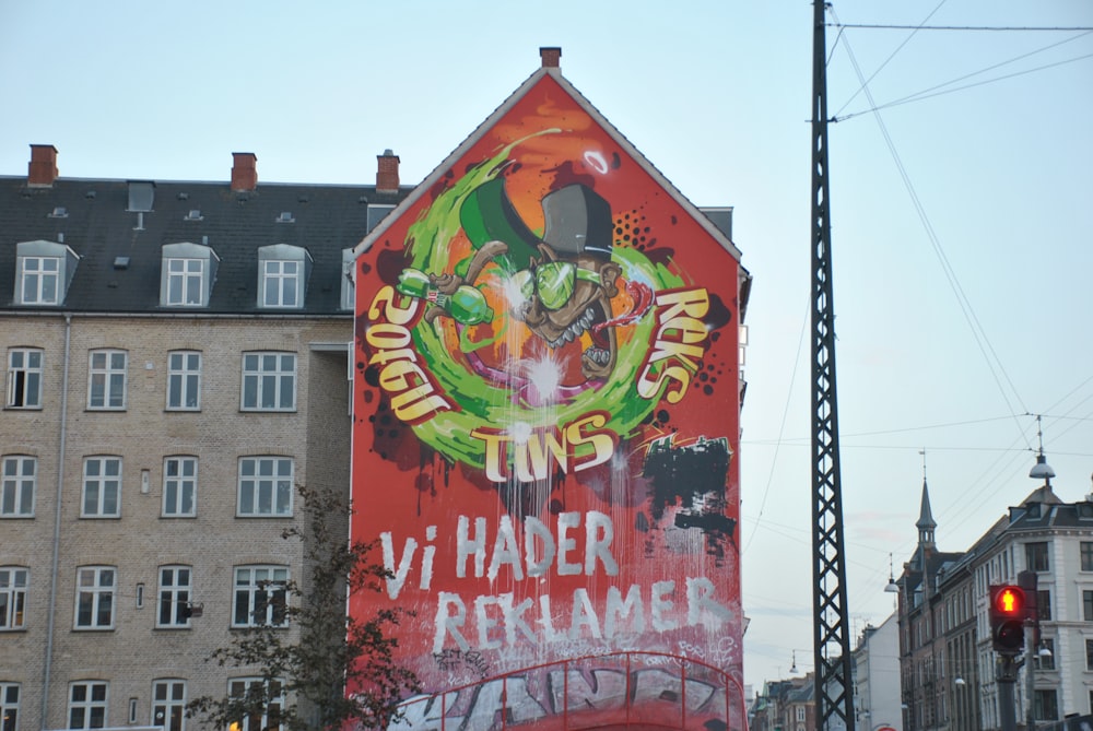 orange and green graffiti covering a building