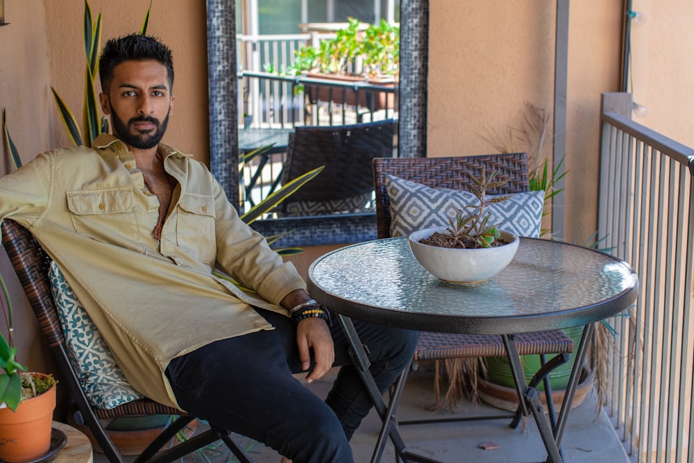 man sitting on chair beside table