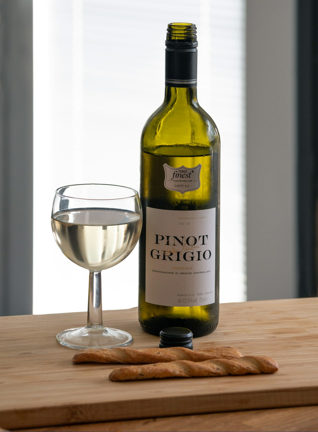 pinot grigio bottle beside glass