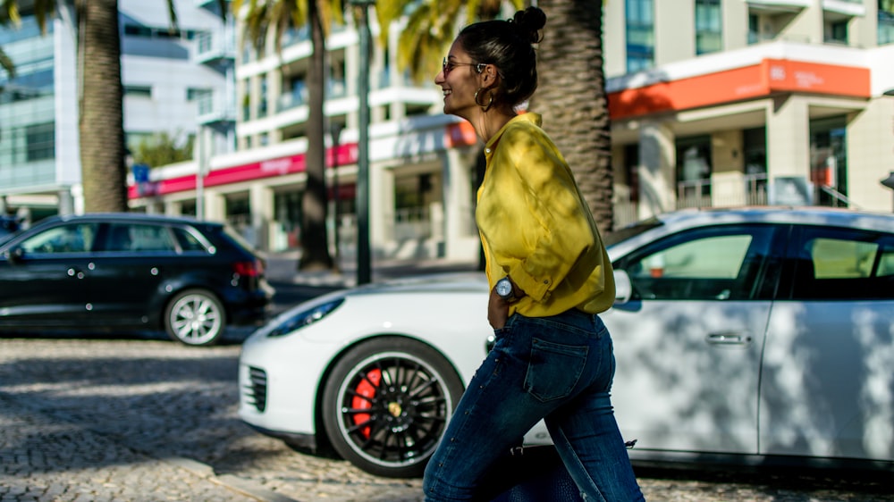 woman walking beside car