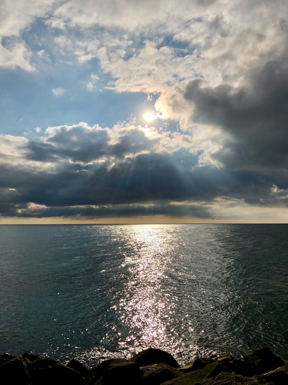 body of water under white clouds