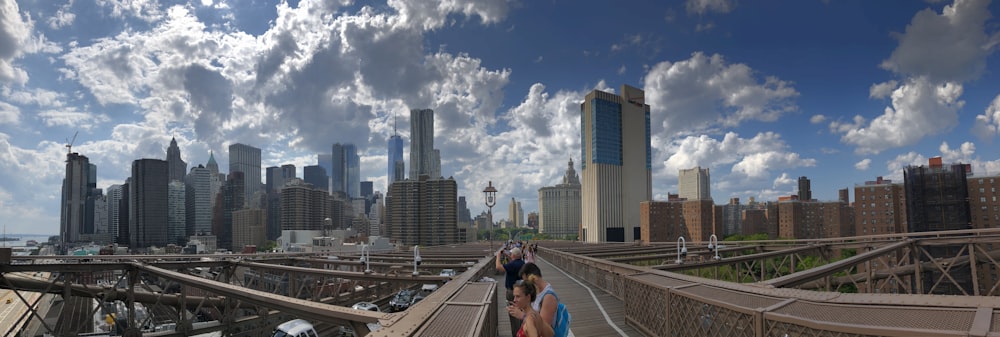 a group of people walking across a bridge