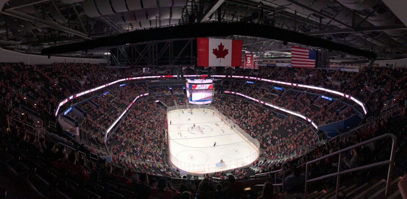 Fans filling the stands inside a hockey stadium on game night