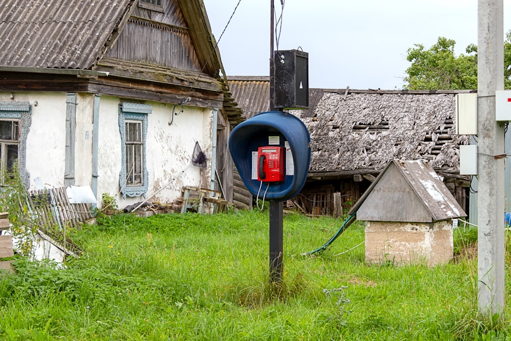 telephone booth near house with attic