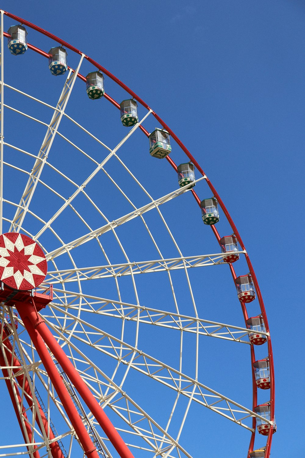 red and white Ferris Wheel under blue sky