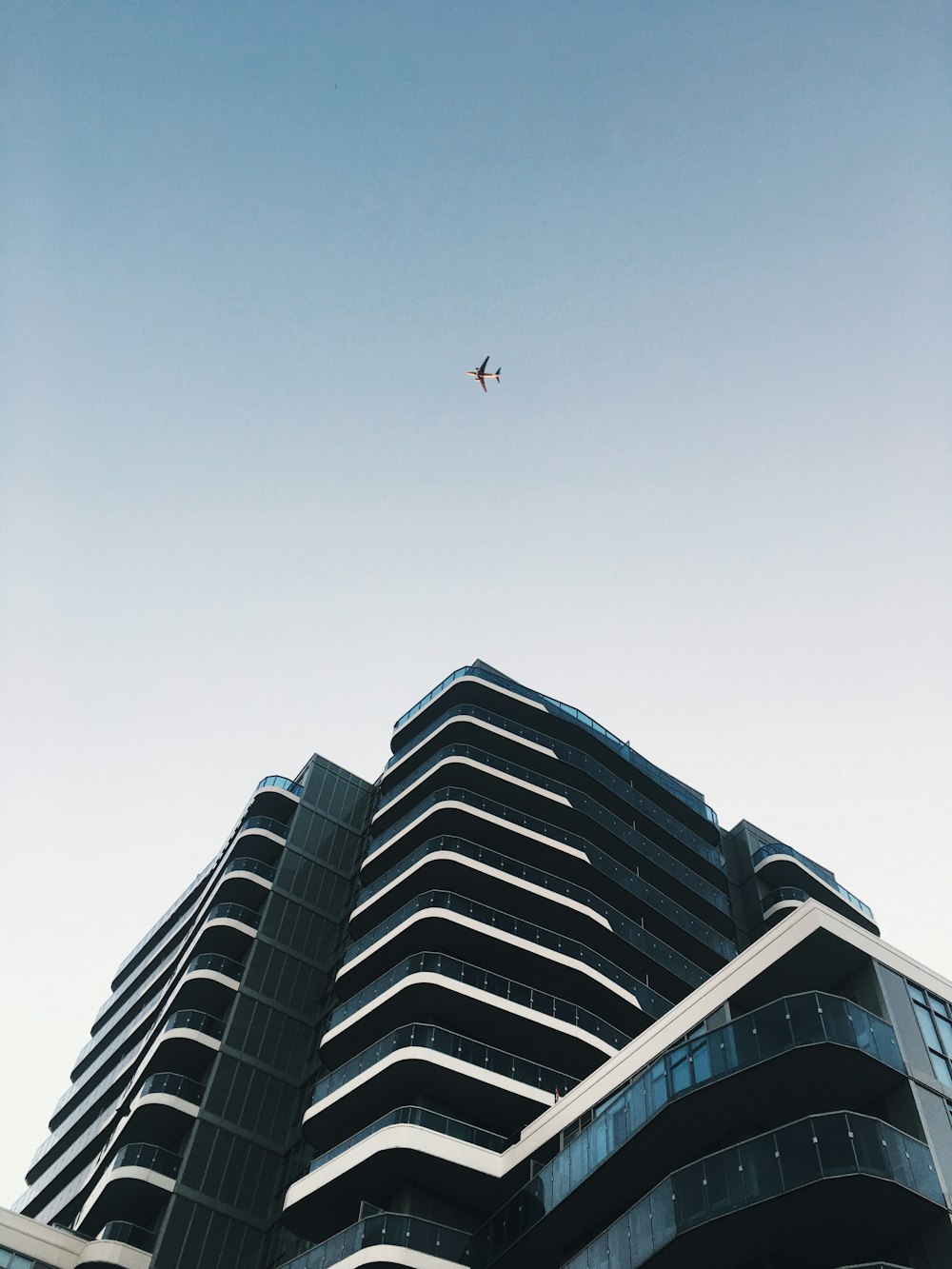 gray airplane under concrete building