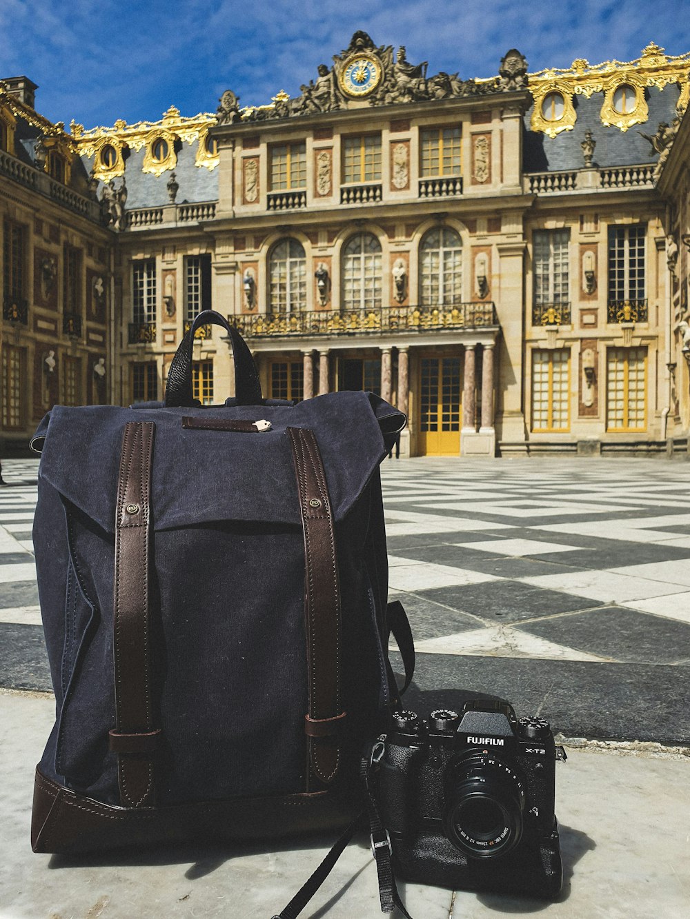 black DLSR camera and bag at Versailles