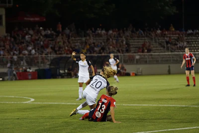 Defender executing a strong tackle to regain possession.