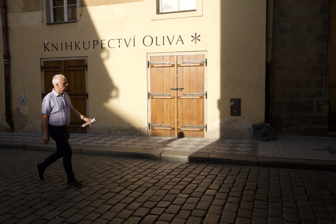 man walking in brown brick street,