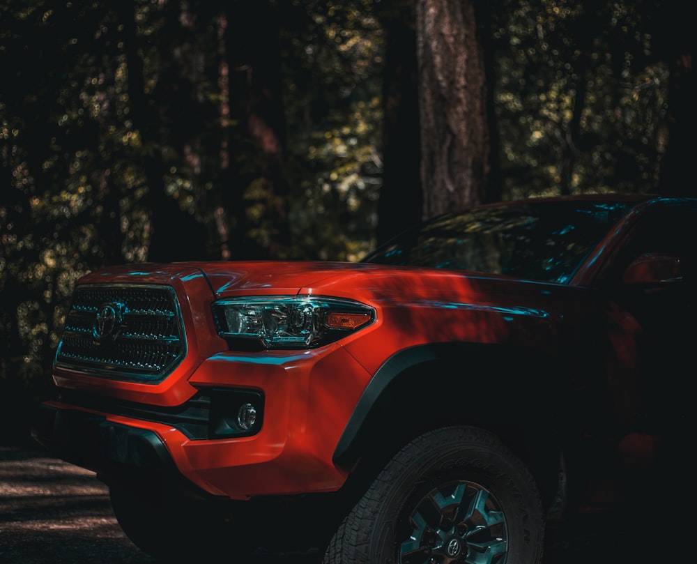 red vehicle near tree