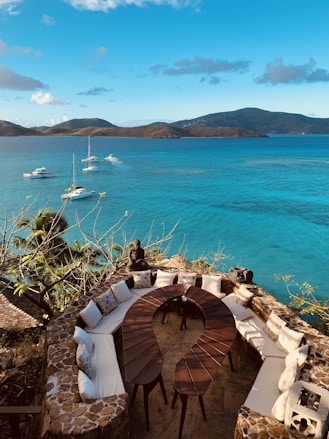  lapping at the shore, sun-drenched beaches, scattered colorful wildflowers, panoramic views of 