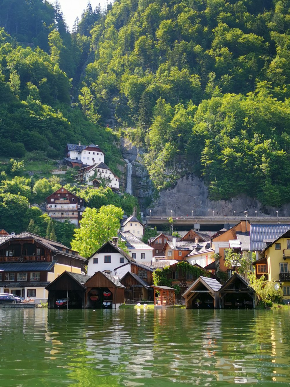 white and brown buildings above body of water