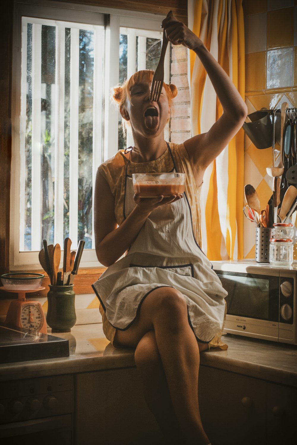 woman wearing white apron sitting on kitchen