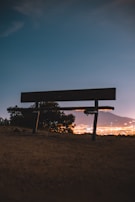 Evening city skyline with a Lumina Apparel tote bag resting on a bench nearby.