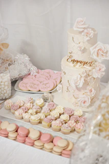 Delicate pink and gold themed cake display arranged for an elegant engagement party