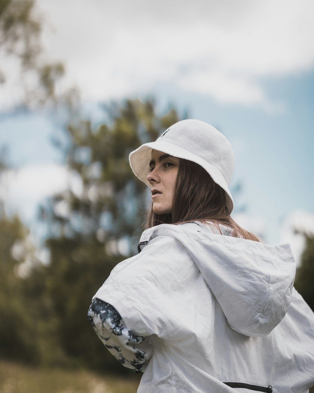 woman wearing white hat and hooded jacket