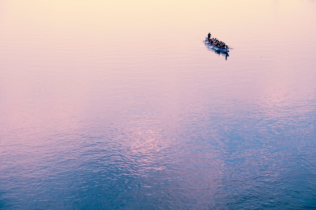 human-powered watercraft at the calm body of water