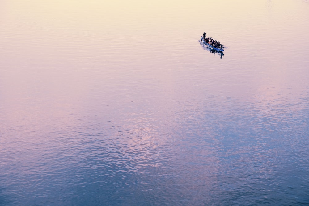 human-powered watercraft at the calm body of water