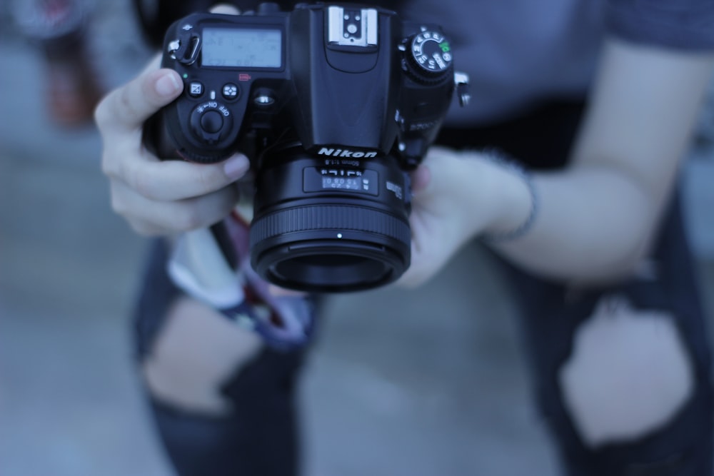 selective focus photography of person holding camera