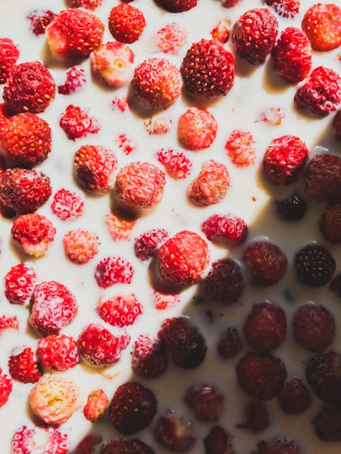 Bright red strawberry pulp with fresh strawberries around