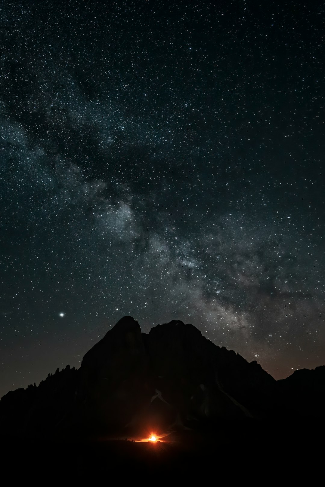 silhouette of mountain under starry sky