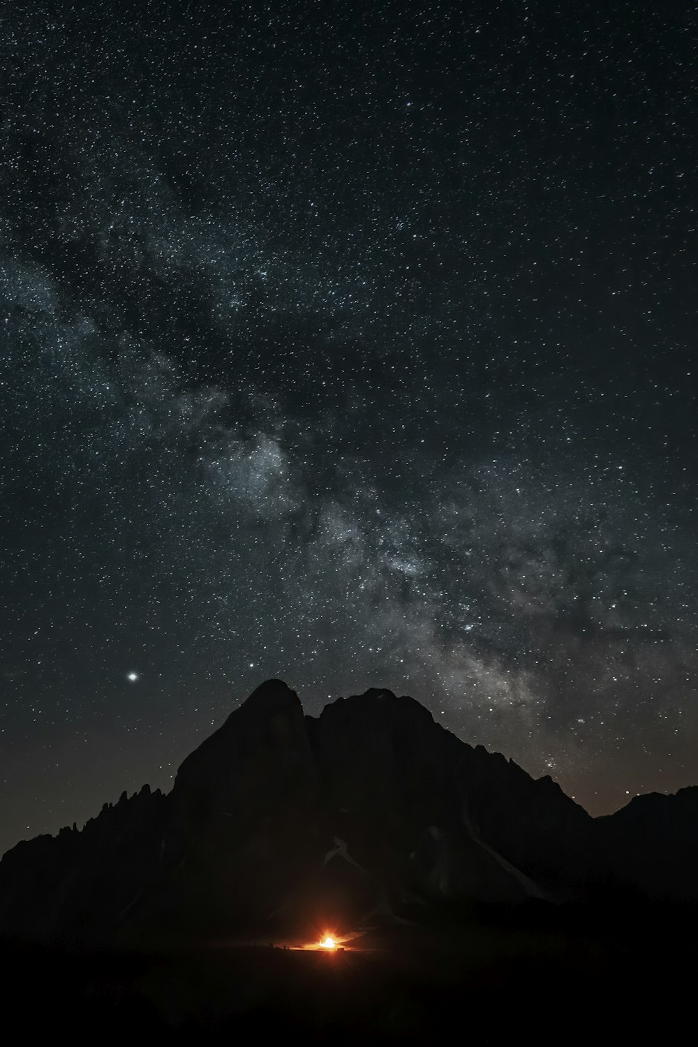 silhouette of mountain under starry sky