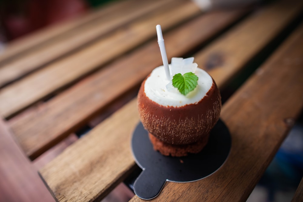 coconut cup with straw and leaf on black base