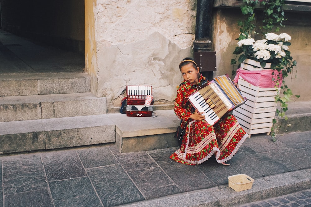 girl playing accordion in street