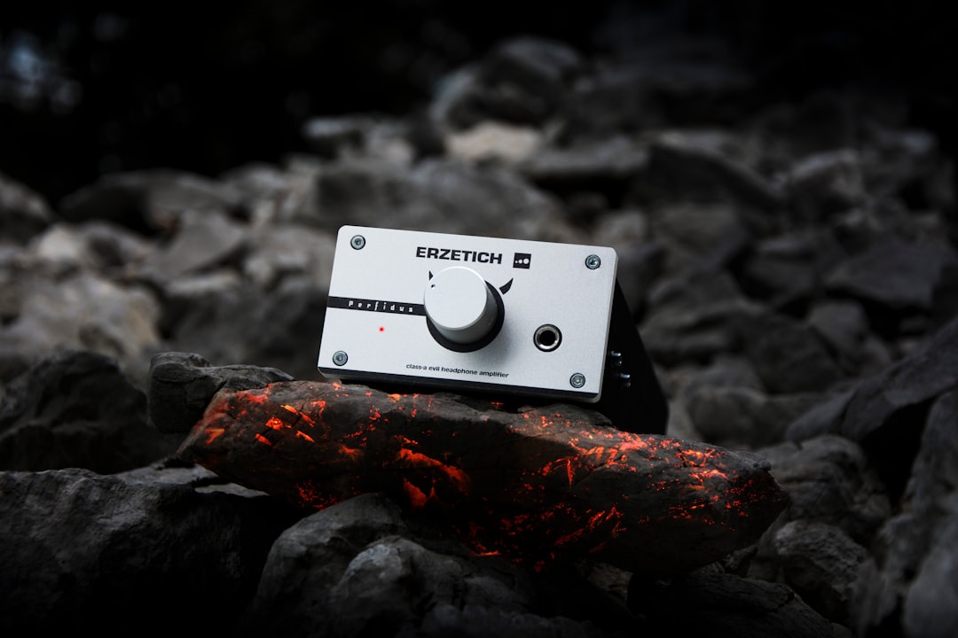 Headphone amplifier on a burning coal background.