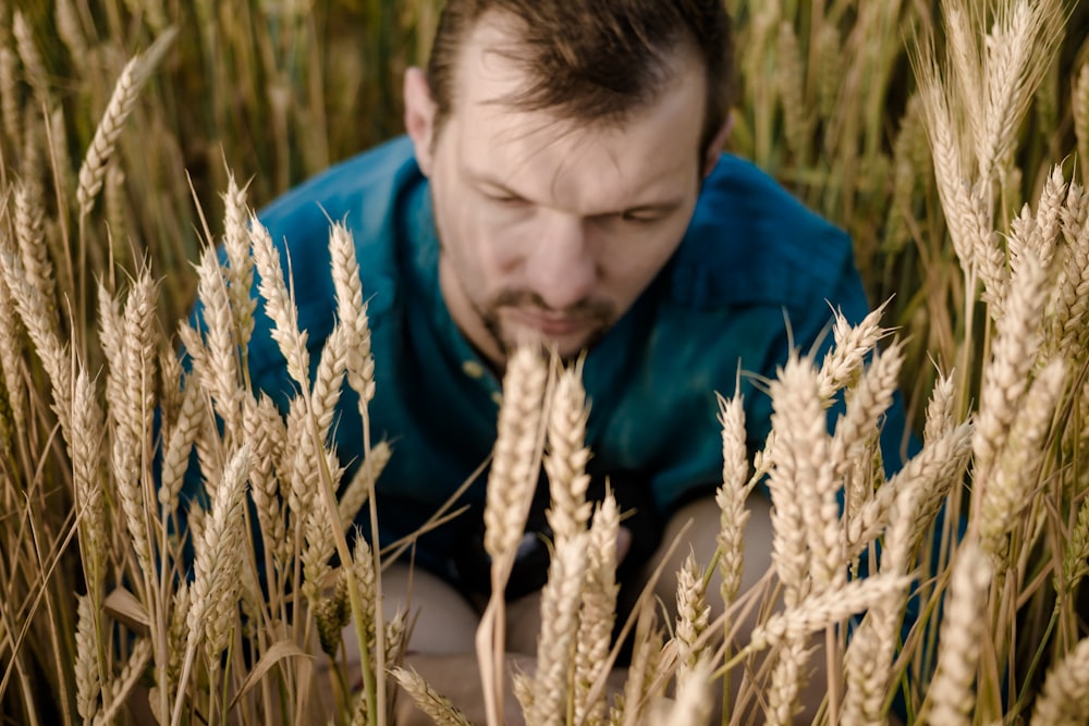 selective focus photography of man near wheat field