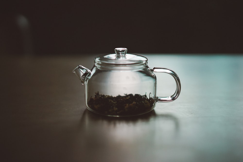 clear glass teapot on wooden surface