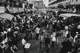 grayscale photo of people busy street