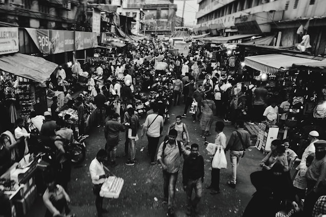 grayscale photo of people busy street