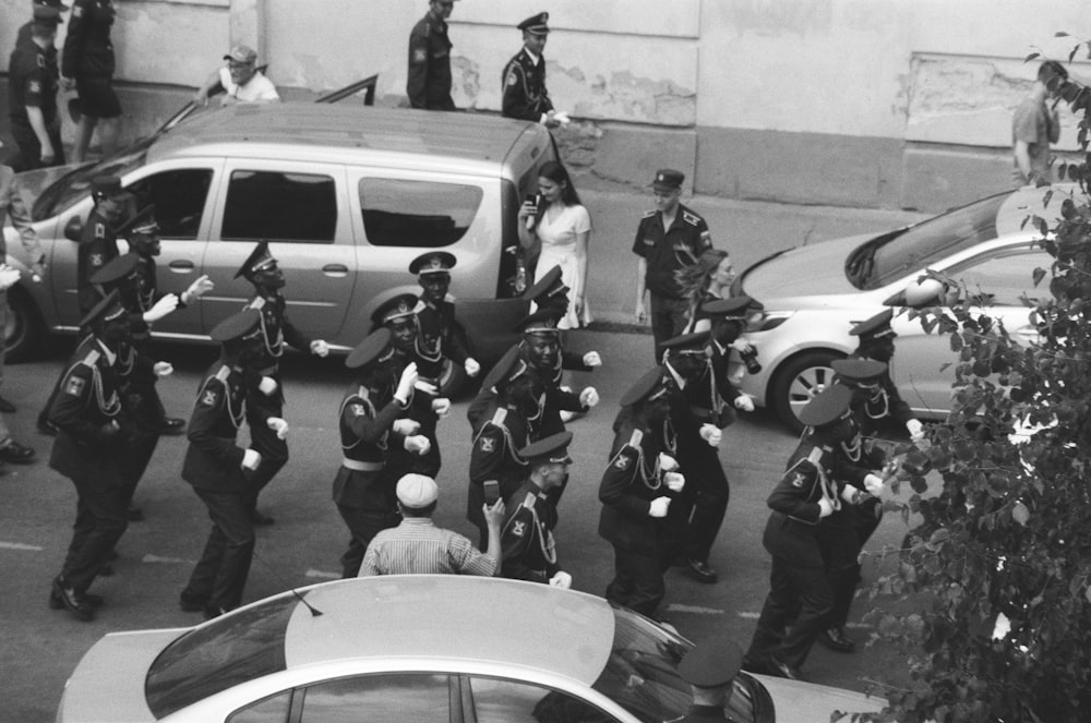 grayscale photo of royal guards on road