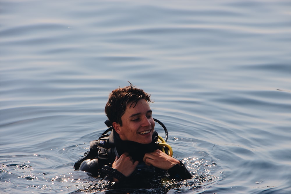 smiling man on body of water