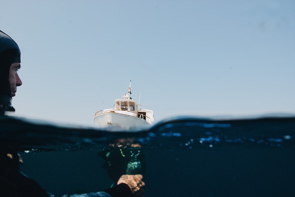 person on body of water near boat