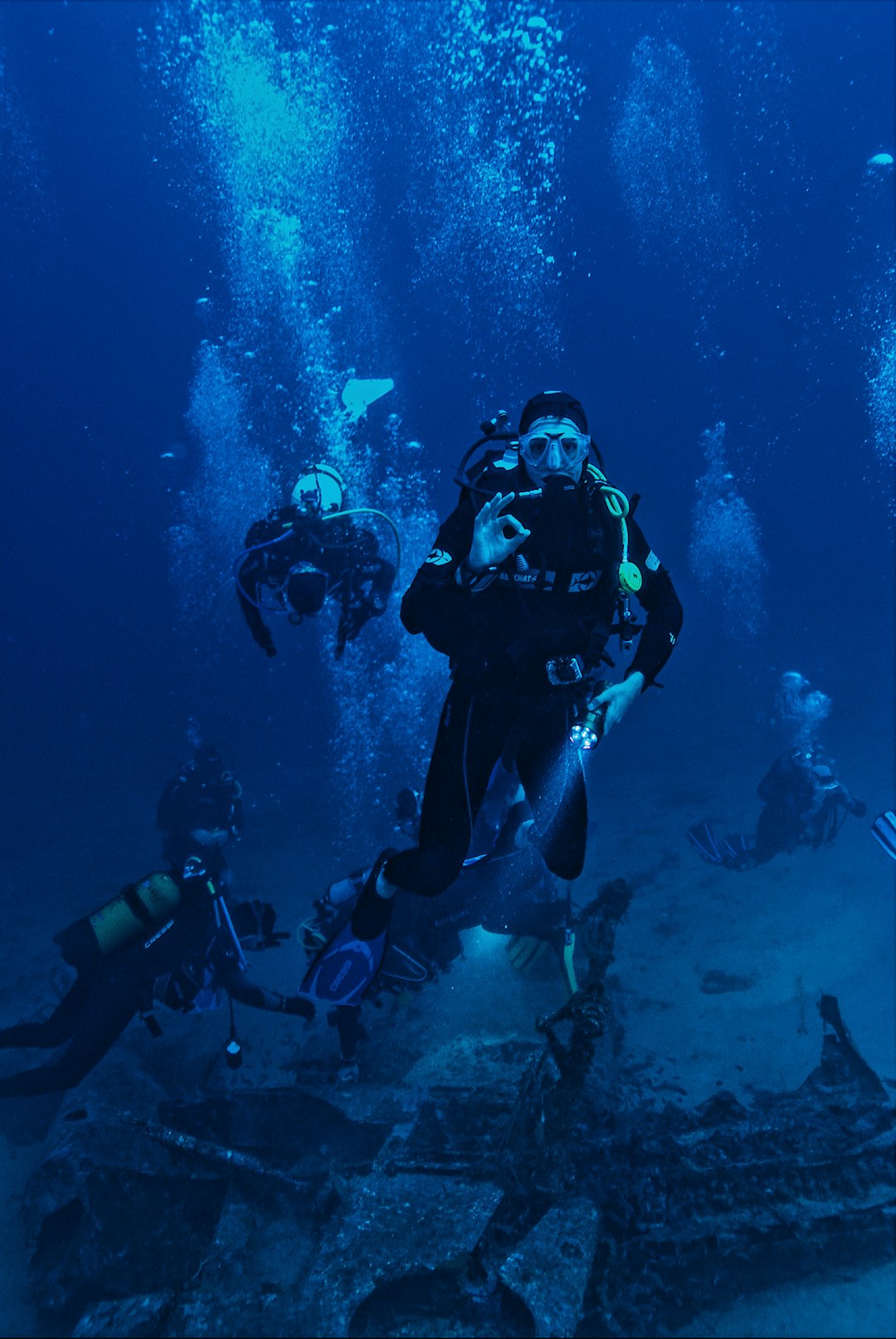 people diving in body of water