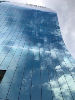 A sleek glass facade reflecting the skyline.