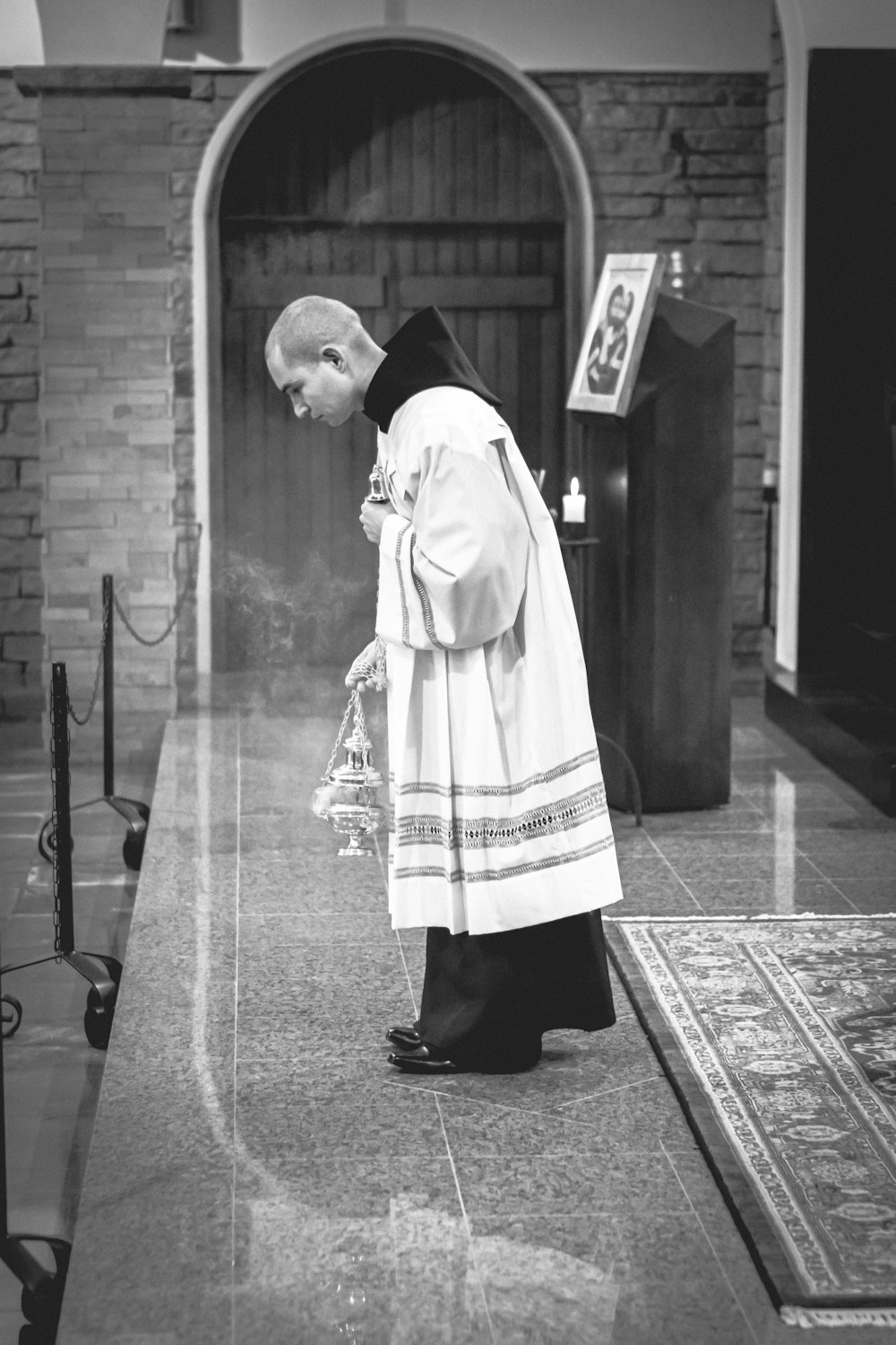 grayscale photography of man doing vow on stage