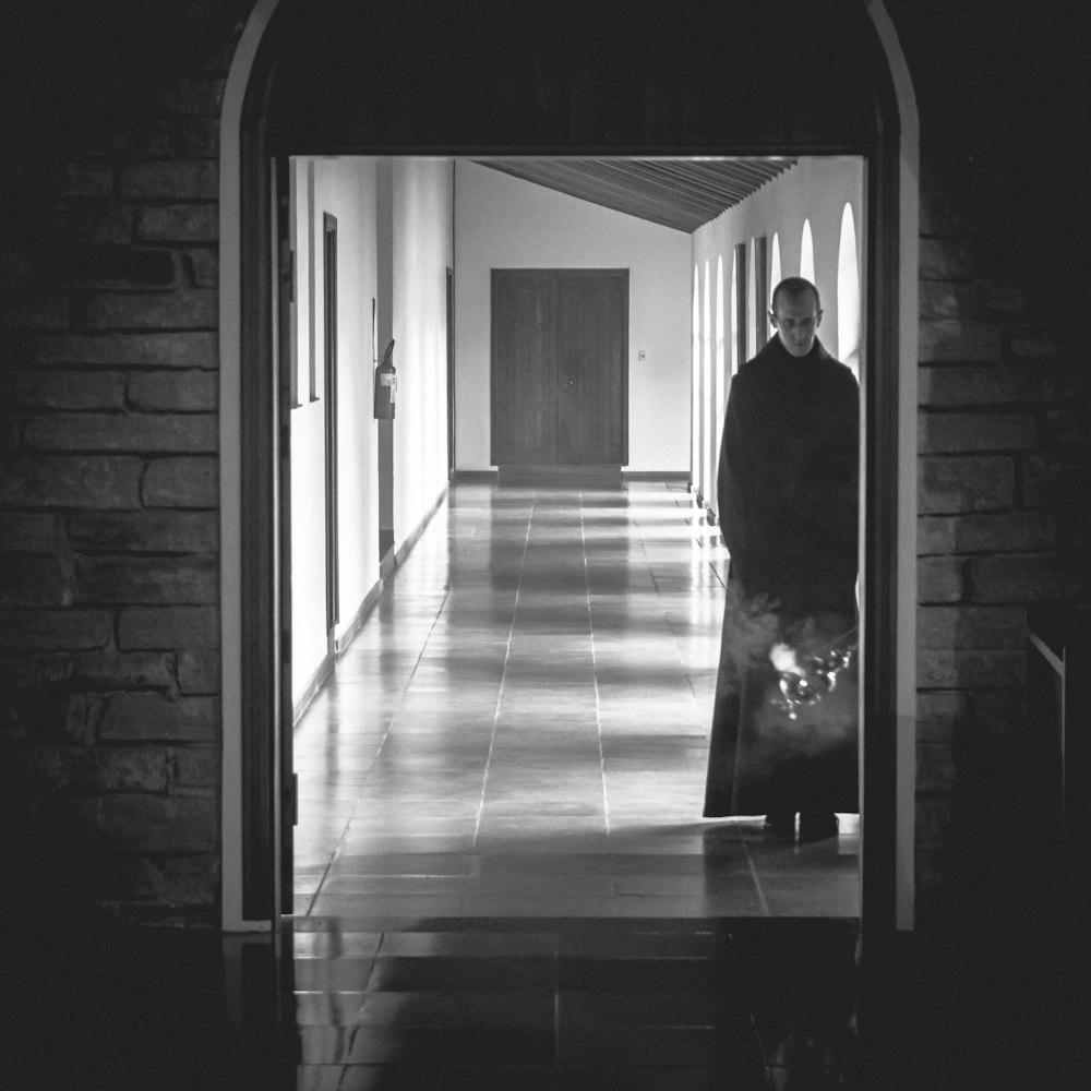 man standing at the side of the open door