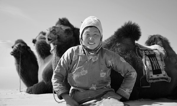 Woman sitting near animal — Gobi Desert, Mongolia