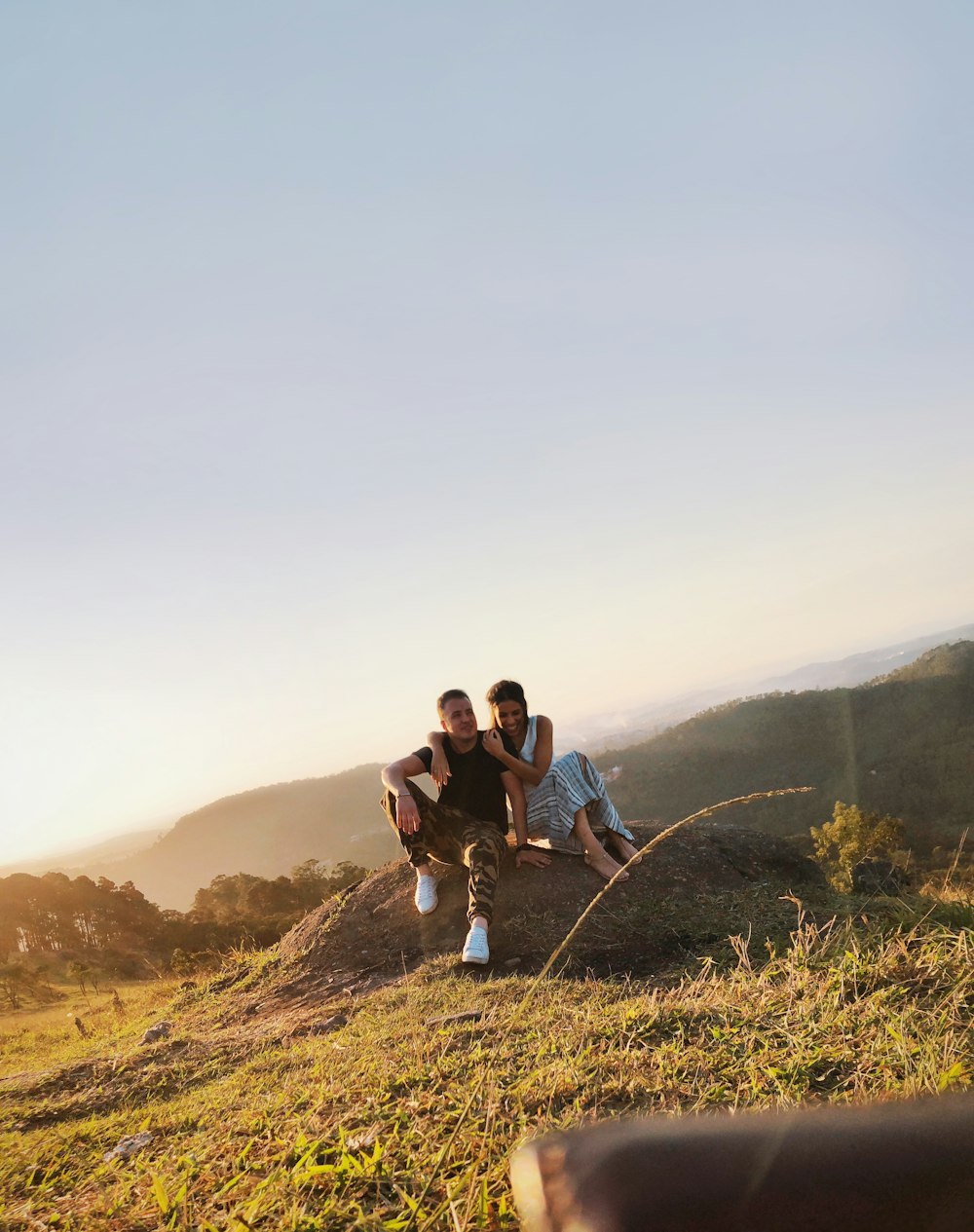 photography of man and woman sitting on ground during daytime