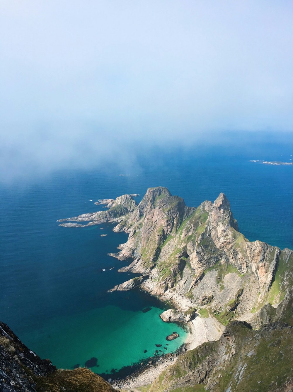 aerial photography of mountain near body of water during daytime